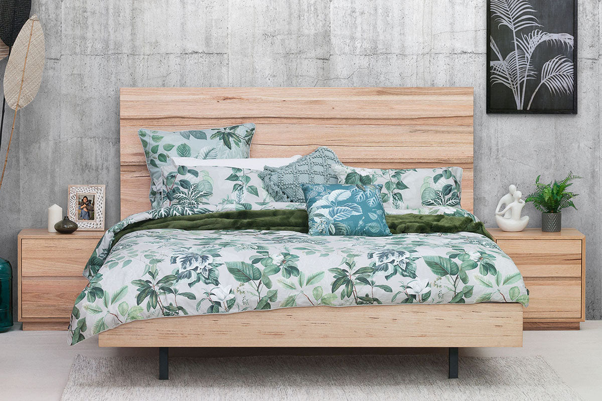 Timber bed frame with botanical bedding