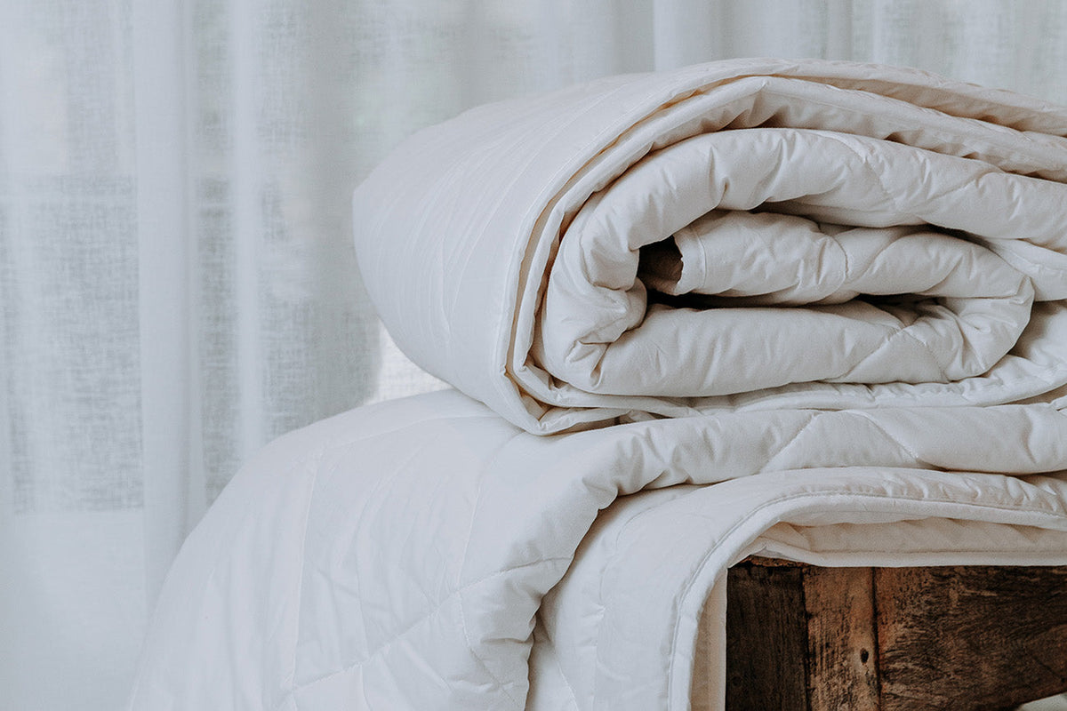Wool quilt on a made bed